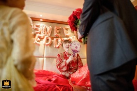 Bride with a mask on a bed at the Millennium Hotel Beijing wedding.